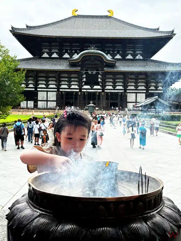 Una niña enciende incienso en el Templo Todaiji de Nara